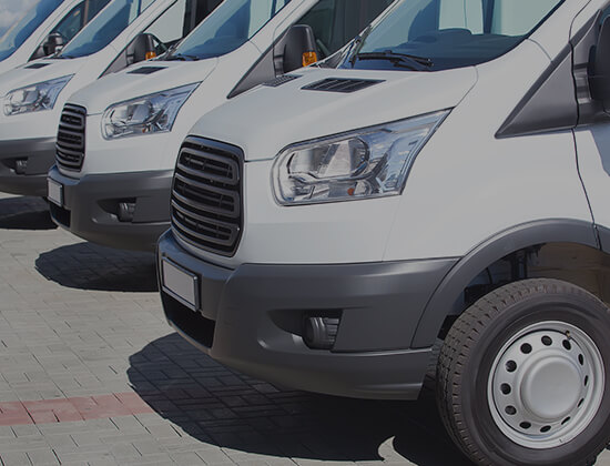 Ford Transit minibuses parked at depot